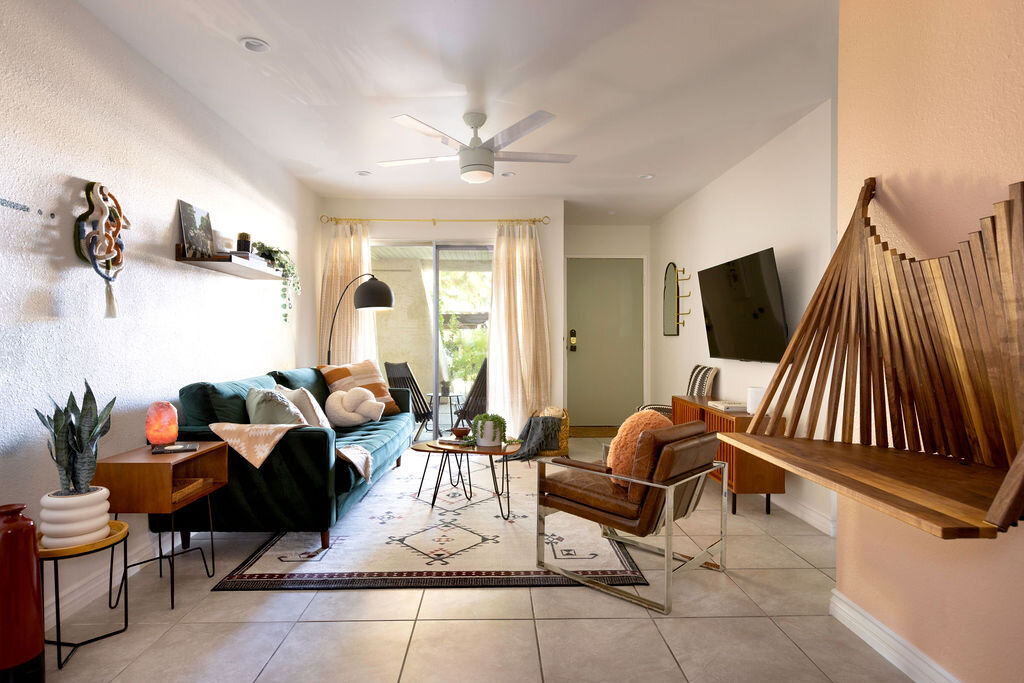 The Well living room with teal velvet sofa and mid-century modern design in Palm Springs